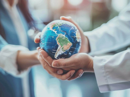 Two people are holding a small globe together.